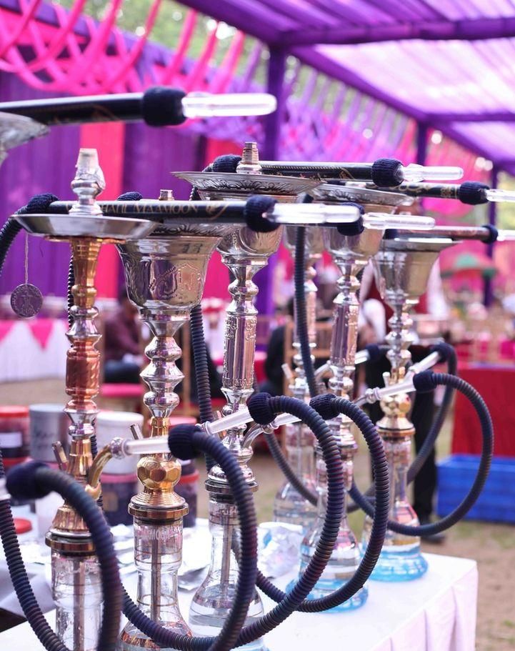 Row of silver and gold hookahs at an event